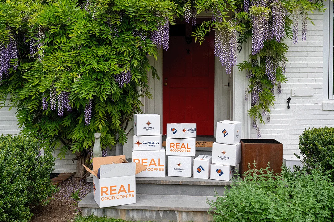 Compass Coffee subscription boxes delivered at a doorstep